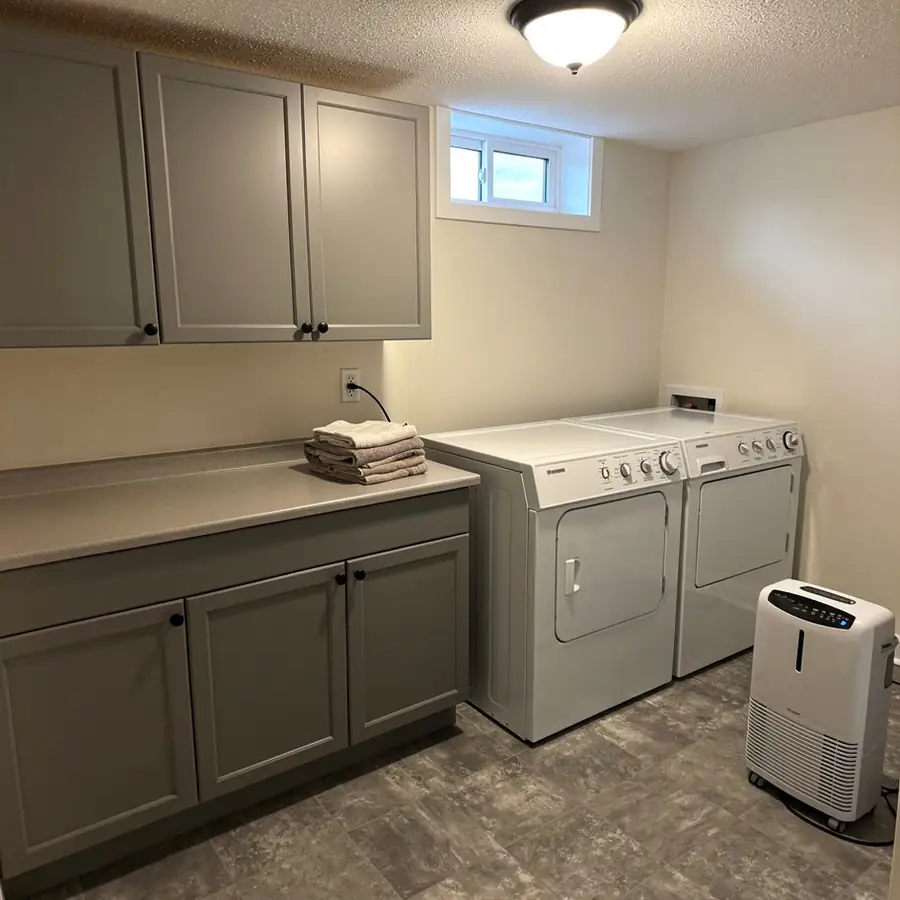 Basement laundry cabinets painted warm grey