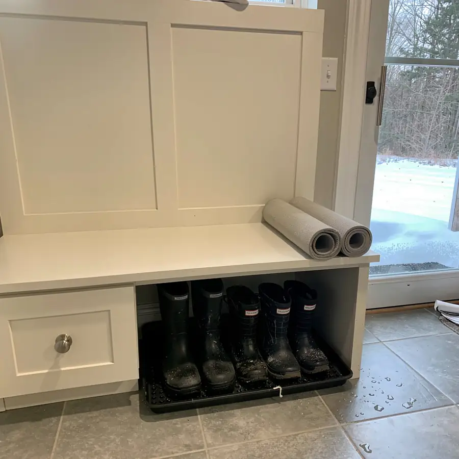 Boot tray under cream mudroom bench