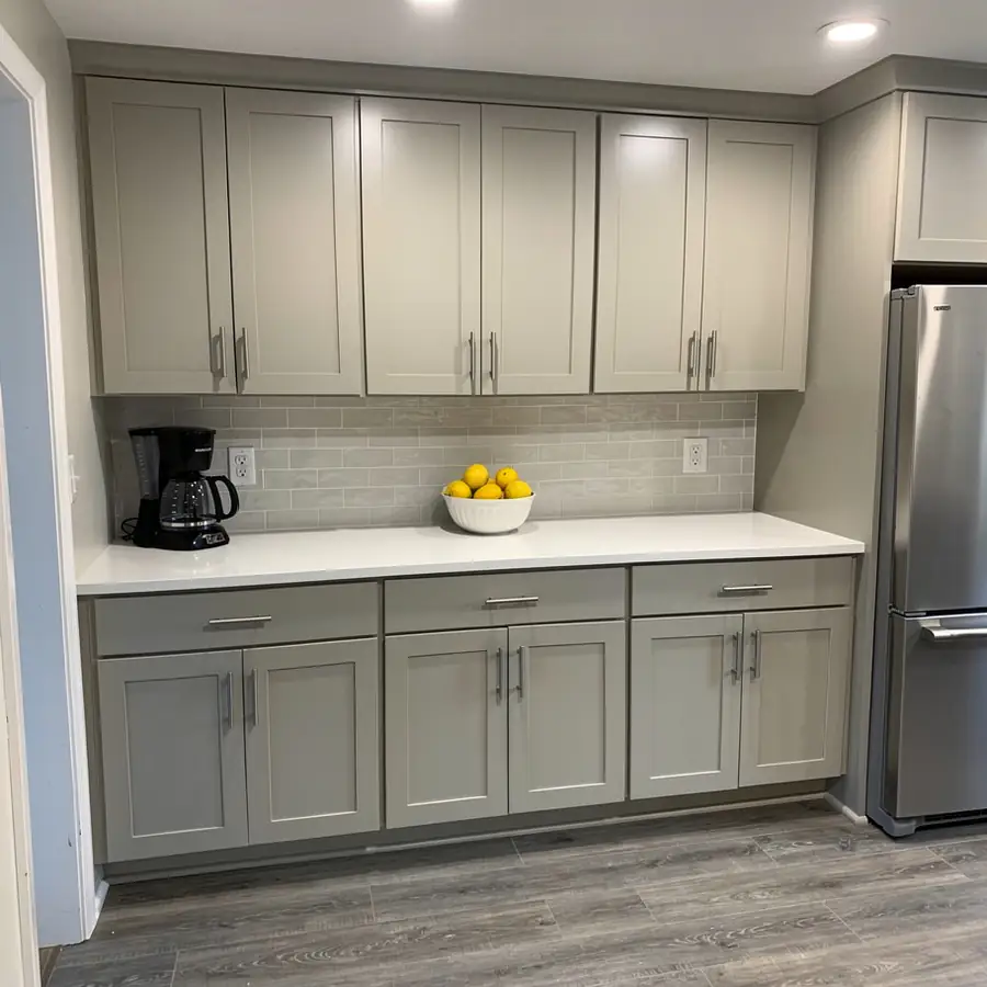 Brushed nickel pulls on greige cabinets