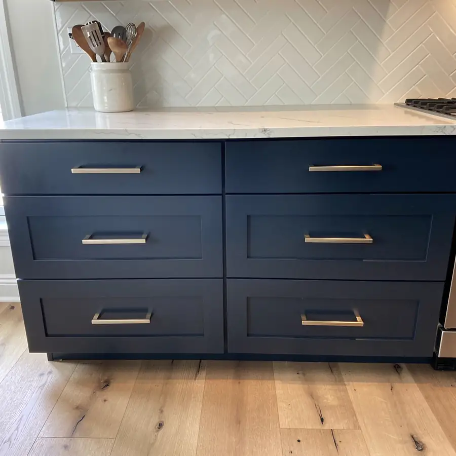 Champagne bronze pulls on navy drawers