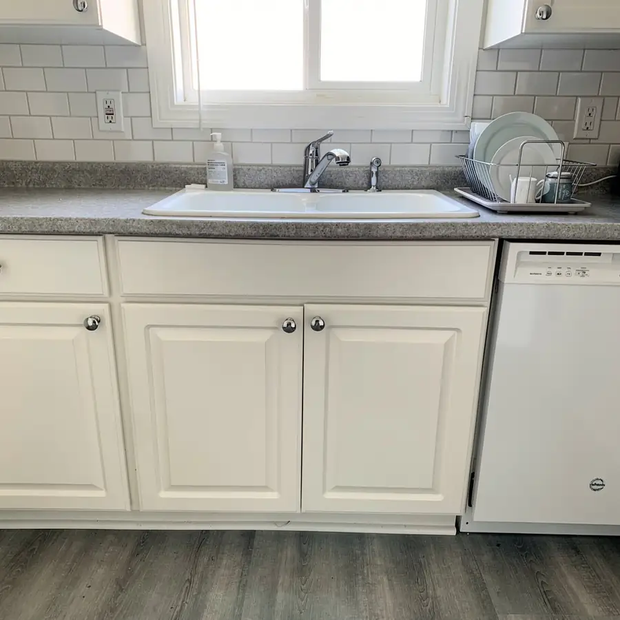 Crisp white oak cabinets beside kitchen sink