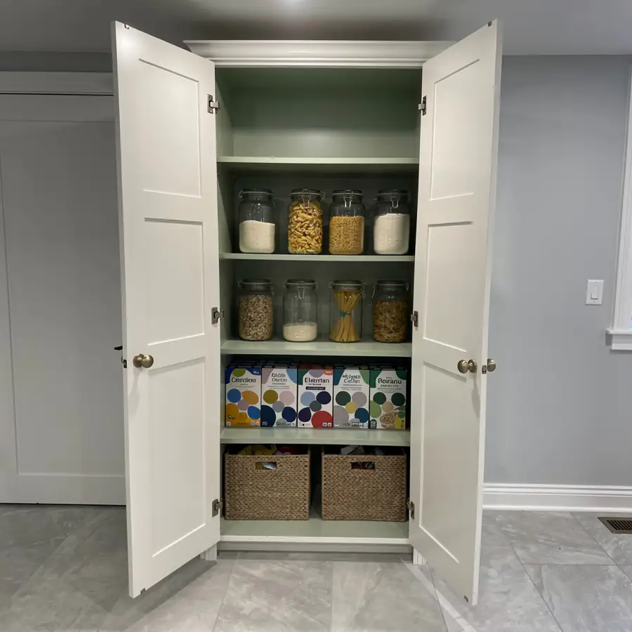Open pantry with sage painted interior shelves