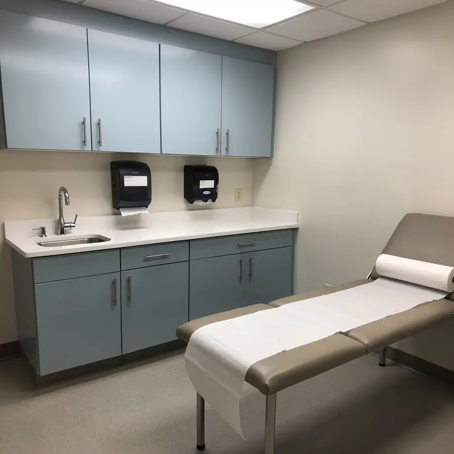 Painted exam room casework in pale blue Painted exam room casework in pale blue
