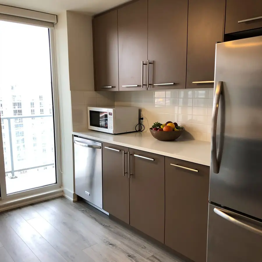 Painted laminate condo kitchen in taupe