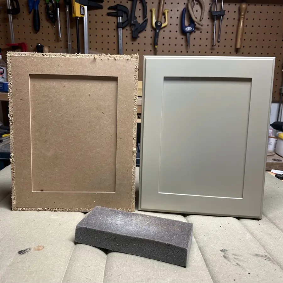 Raw MDF door beside sprayed finished door