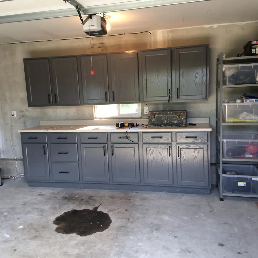 Repurposed oak cabinets painted charcoal in garage