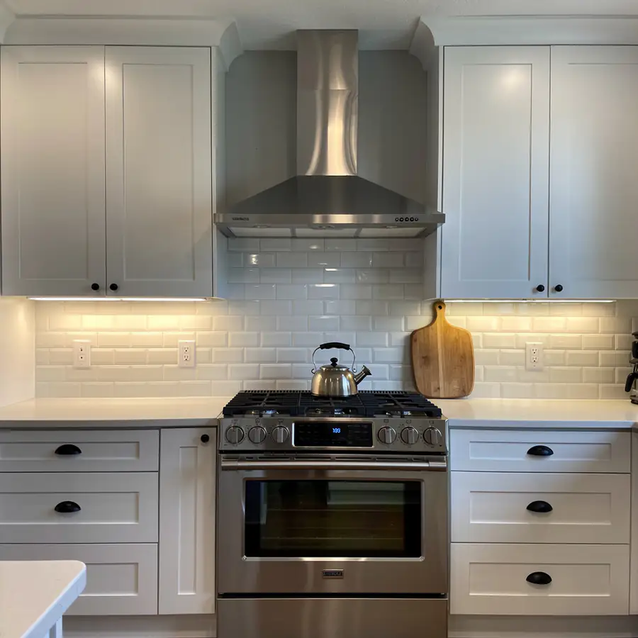 Smooth white Shaker doors near range hood