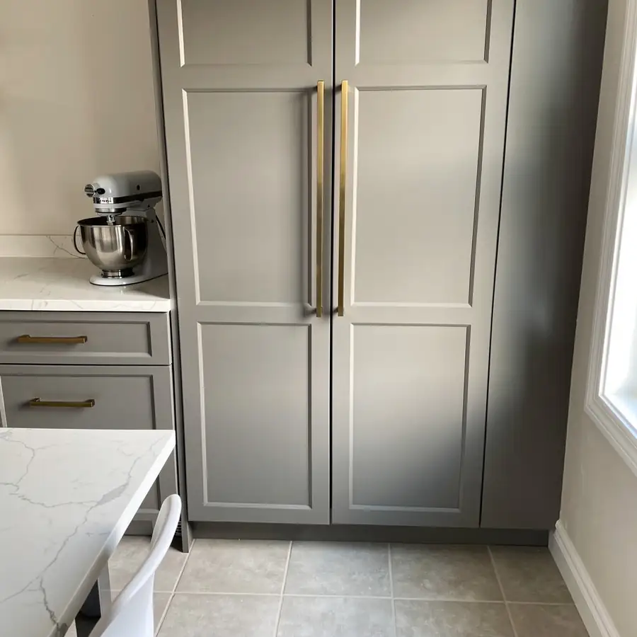 Soft grey pantry doors with brass pulls