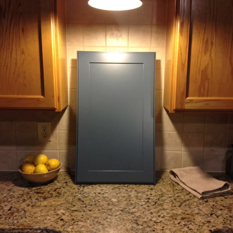 Sprayed blue sample door beside backsplash