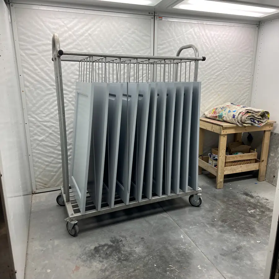 Sprayed doors drying on spray booth racks