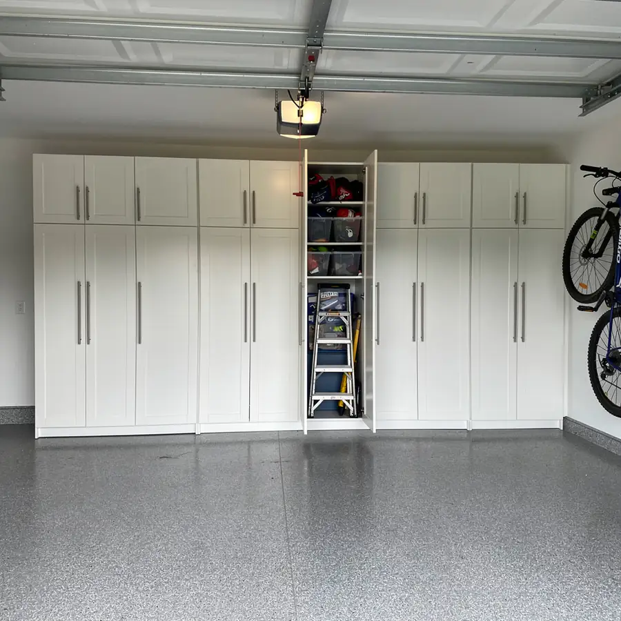 Tall white garage storage cabinet wall