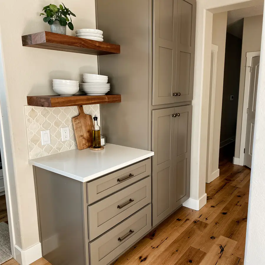 Warm greige Shaker cabinets with walnut shelves