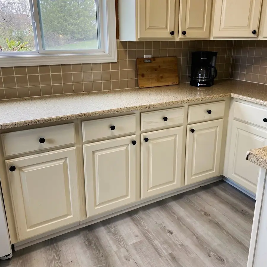 Warm white kitchen cabinets with quartz counters