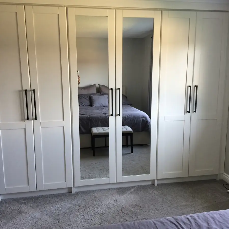 White painted wardrobe with mirror door frames